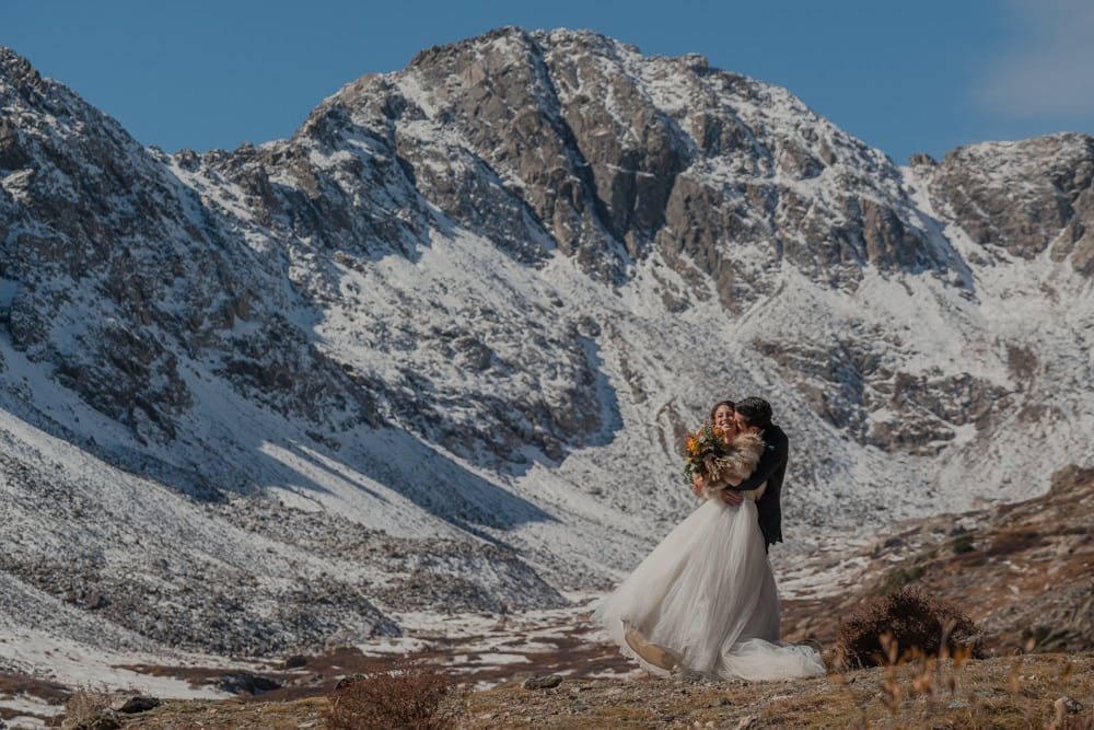 couple playing with each other during their elopement in the mountains