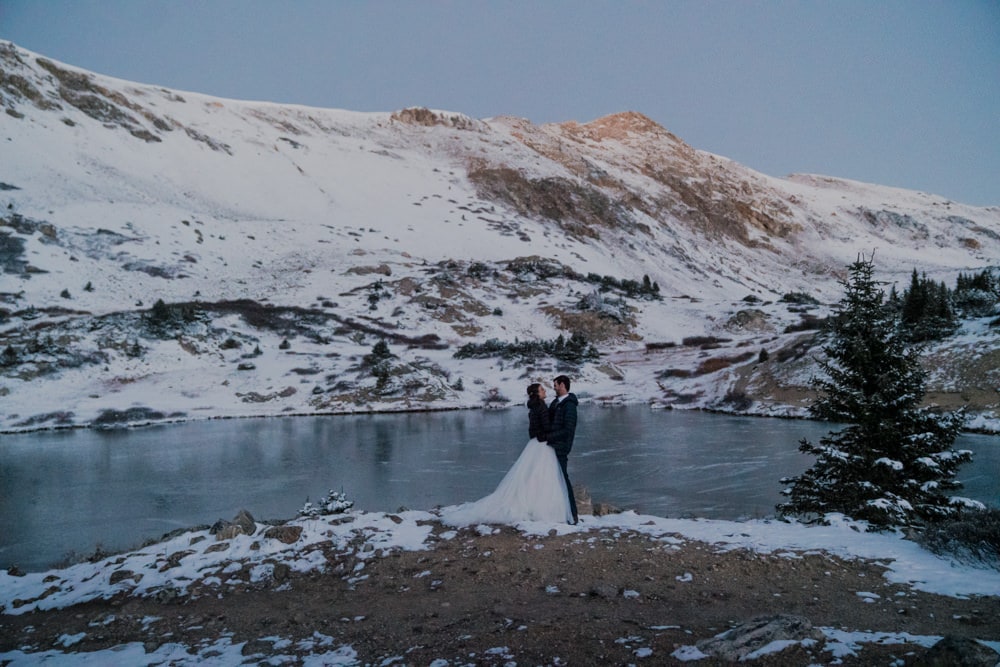 couple's portrait during their sunrise elopement in the mountains