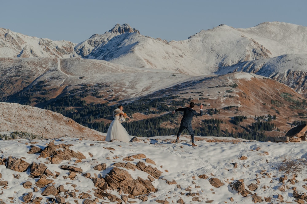 couple eloping at loveland pass and having a snowball fight