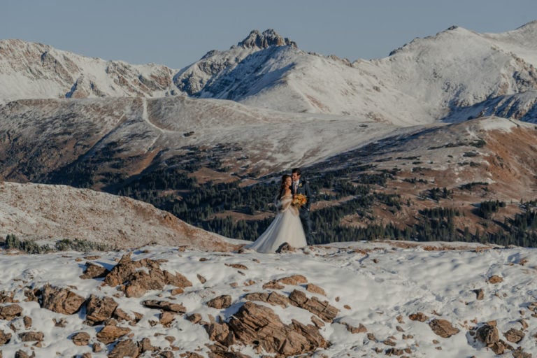 couple poses during their sunrise elopement in the mountains of Colorado