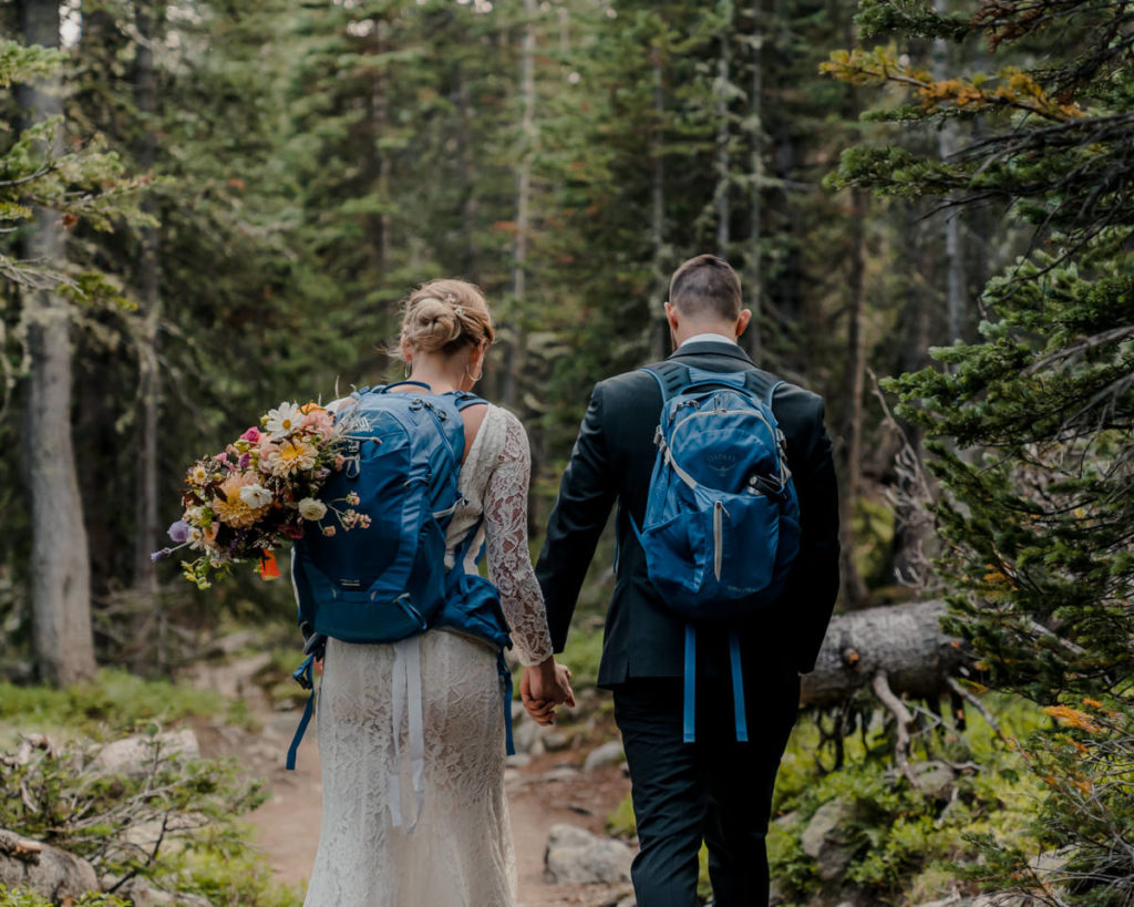 Hiking Elopement Guide. Image of couple hiking during their elopement in wedding attire